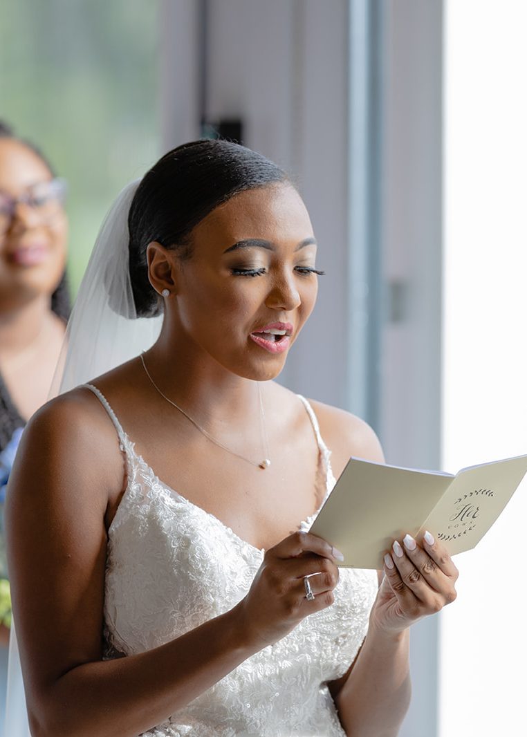 Image of woman reading her vows to her newly wed husband during her wedding day ceremony