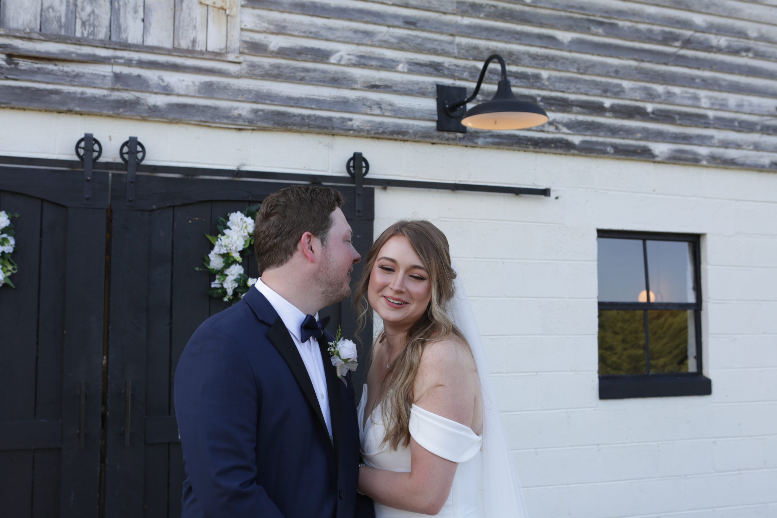 Image of man and woman laughing on their wedding day 